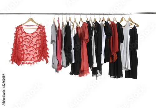 red dress and fashion female clothing hanging on hangers