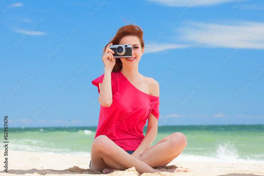 Redhead teen girl with retro camera on the beach Redhead teen girl with retro camera on the beach