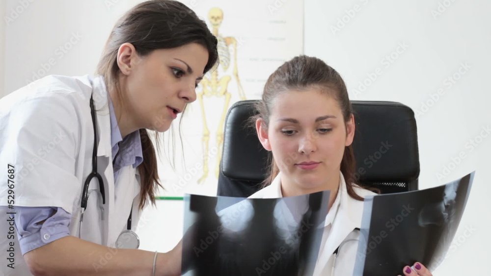 Two female doctors looking at xray picture Two female doctors looking at xray picture