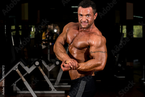 muscular body builder showing his side chest © Jale Ibrak