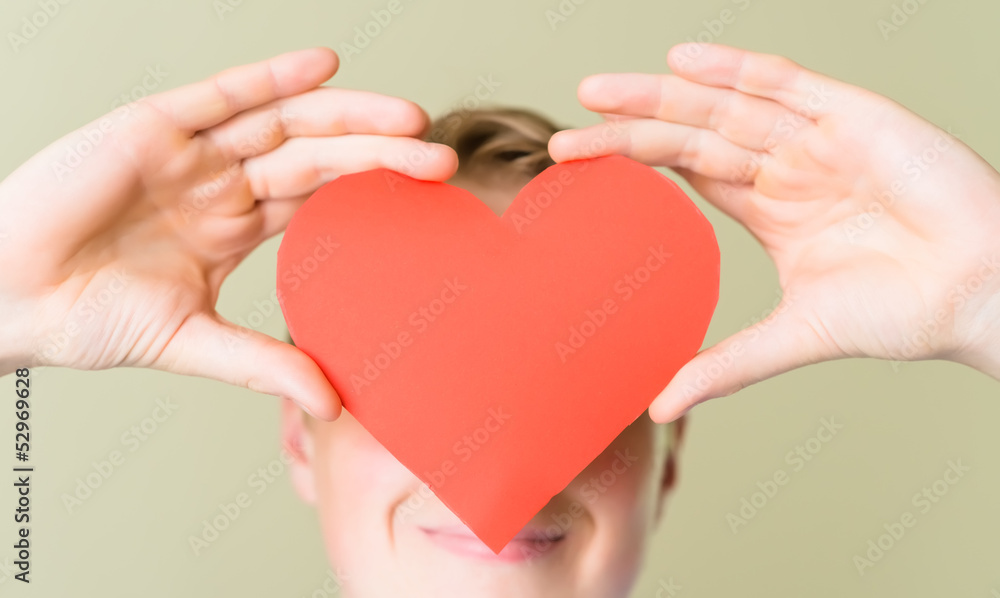 young guy holding a heart young guy holding a heart