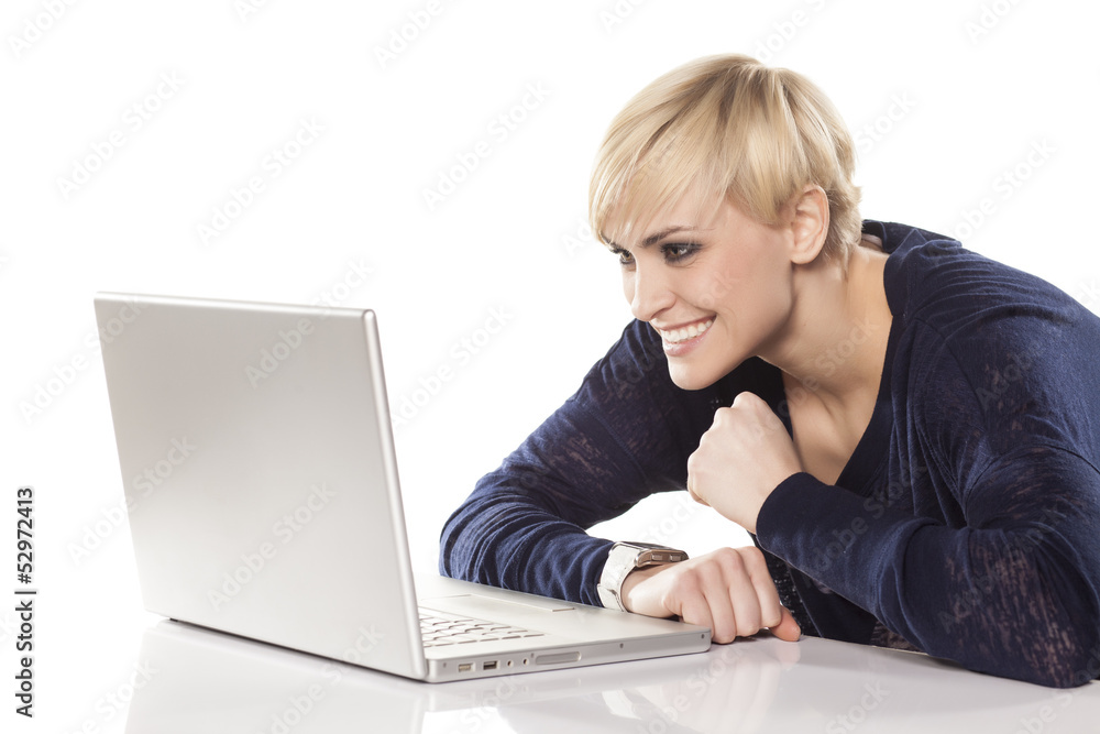 cute smiling blonde working on a laptop on white background cute smiling blonde working on a laptop on white background