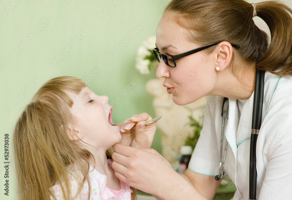 Pediatrician examining little girl's throat Pediatrician examining little girl's throat