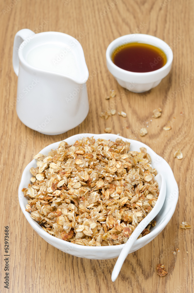 homemade muesli, jug of milk and a bowl of honey for breakfast homemade muesli, jug of milk and a bowl of honey for breakfast