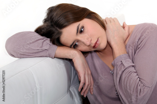 Quadro em tela Sad woman sitting on a sofa