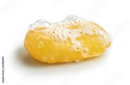 Yellow soap bubble of isolation on a white background photo