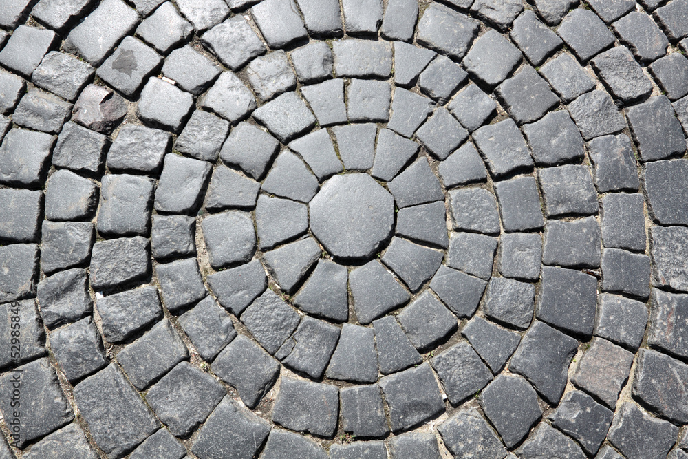 The roadway paved by a grey granite, background The roadway paved by a grey granite, background
