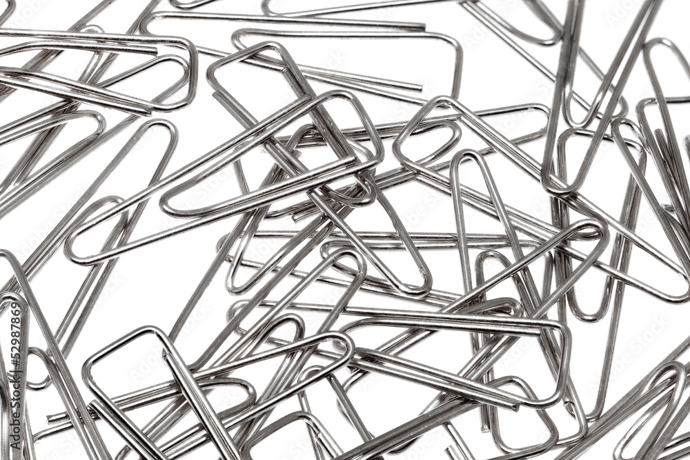 Lot of paper clips against a white background.Isolated. Lot of paper clips against a white background.Isolated.