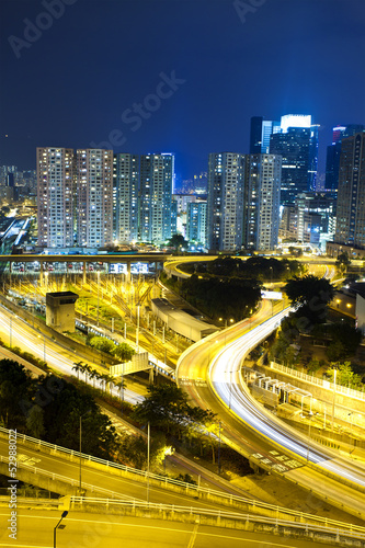Office buildings and highway in city at night