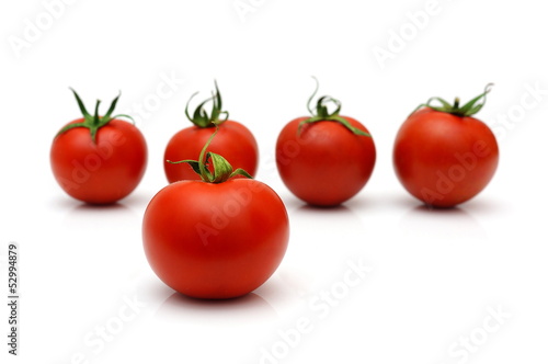 five cherry tomatoes with four in blur