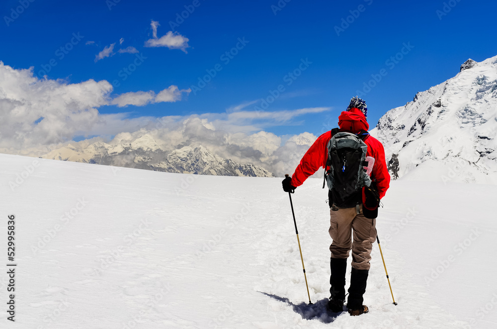 Mountain trekker looking at high winter Himalayas mountains Mountain trekker looking at high winter Himalayas mountains