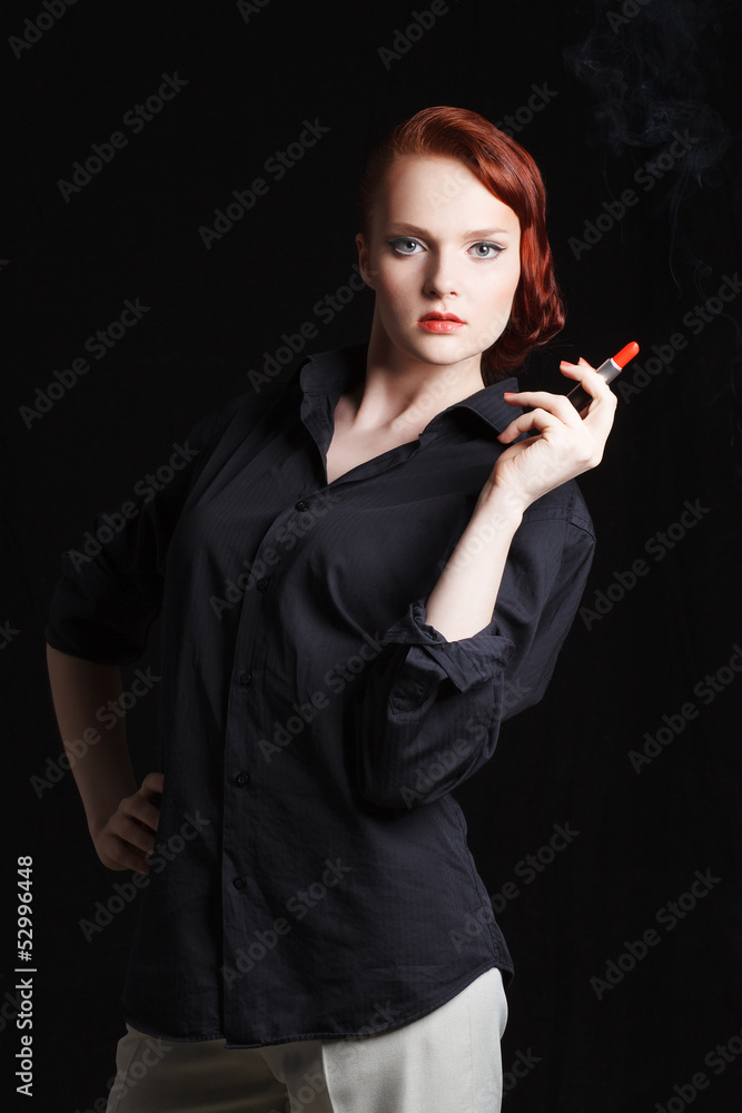 Obraz premium Attractive redhaired young woman holding lipstick like a cigar