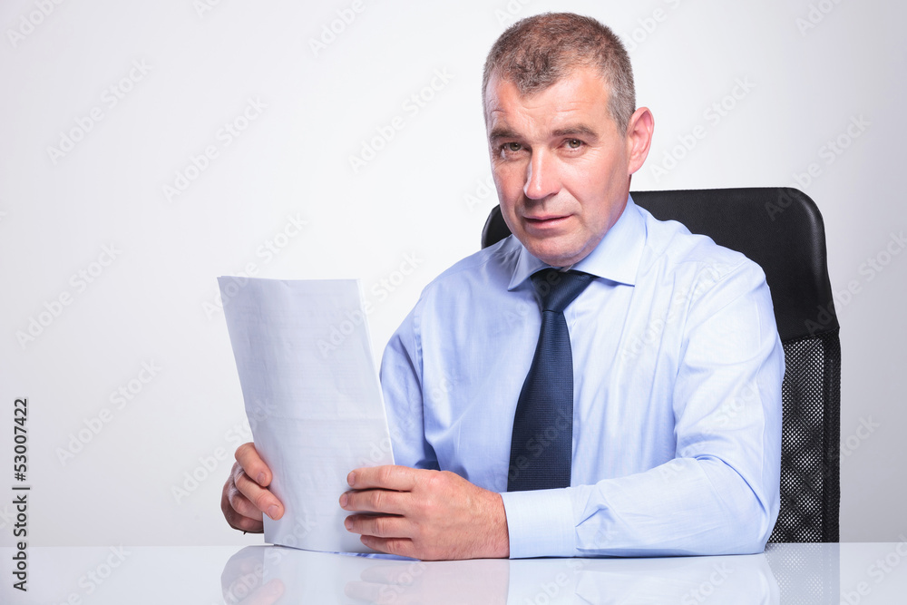 old business man sits at desk with documents old business man sits at desk with documents