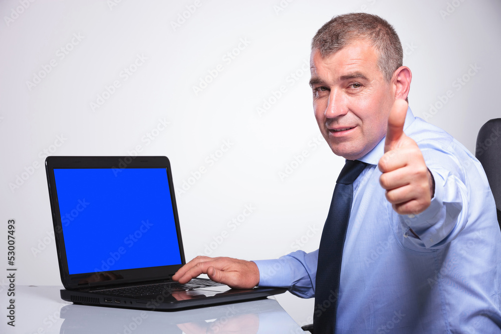 old business man shows ok from laptop old business man shows ok from laptop