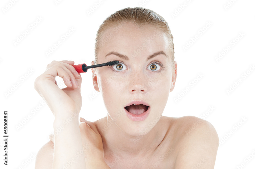 Funny woman applying cosmetics mascara brush on white Funny woman applying cosmetics mascara brush on white
