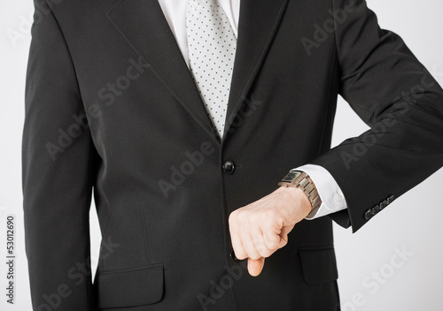 man looking at wristwatch