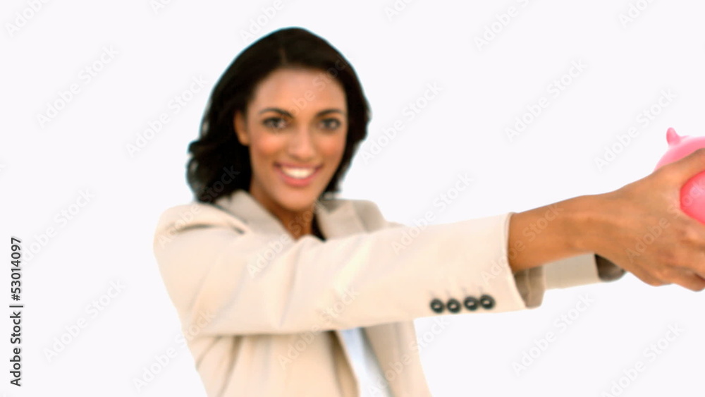 Businesswoman showing piggy bank to the camera Businesswoman showing piggy bank to the camera