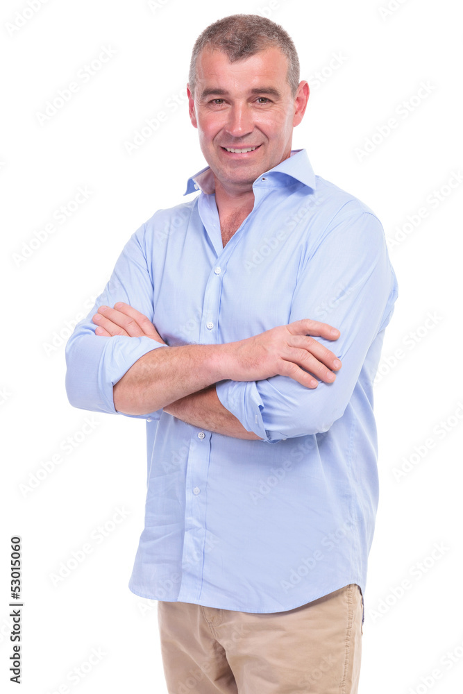 casual middle aged man has his arms crossed casual middle aged man has his arms crossed