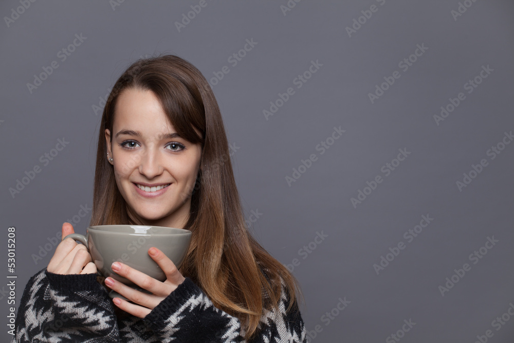 Portrait of a cute young lady in the winter with a cup of tea.. Portrait of a cute young lady in the winter with a cup of tea..