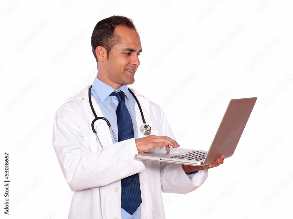 Charming medical doctor using his laptop Charming medical doctor using his laptop