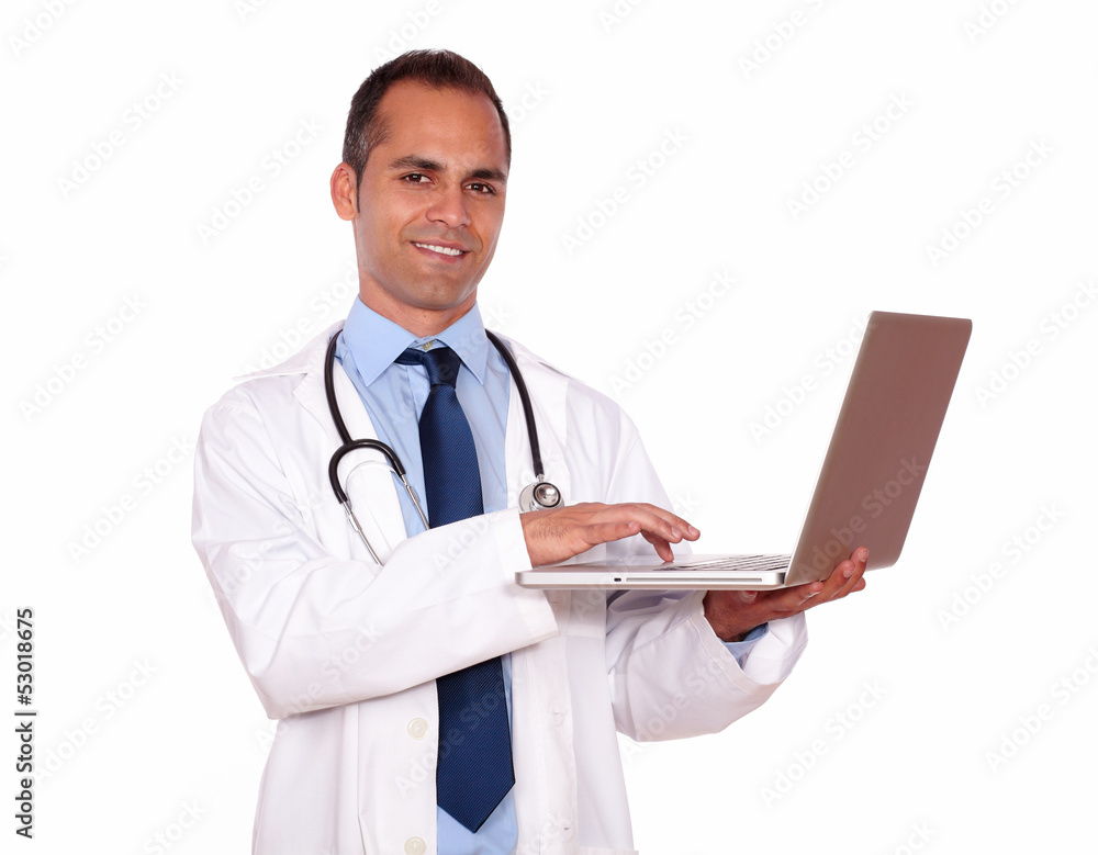 Charming medical doctor working on his laptop Charming medical doctor working on his laptop