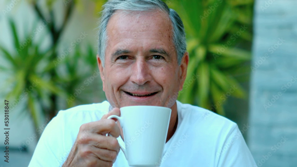 Retired man enjoying coffee outside Retired man enjoying coffee outside