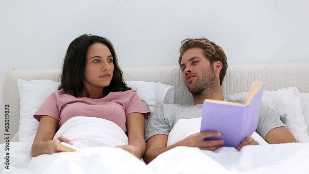 Couple talking about the books they are reading Couple talking about the books they are reading