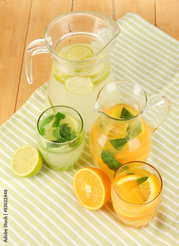 Orange and lemon lemonade in pitchers and glasses Orange and lemon lemonade in pitchers and glasses