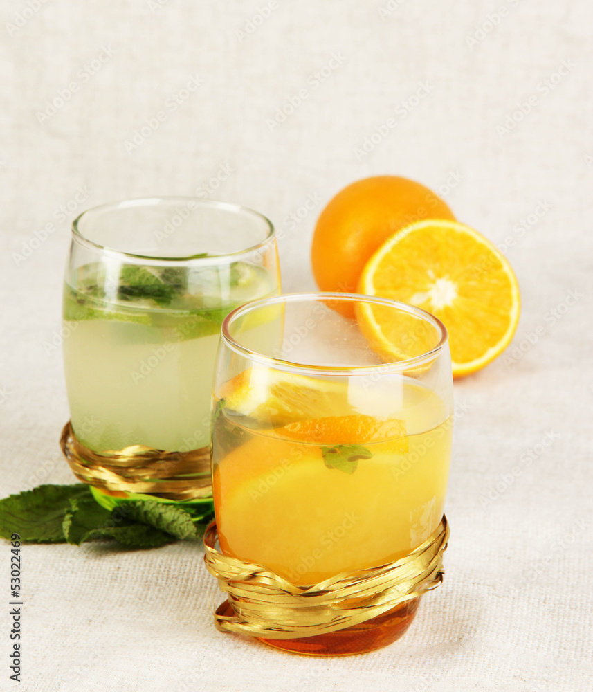 Lemonade in glasses on fabric background close-up Lemonade in glasses on fabric background close-up