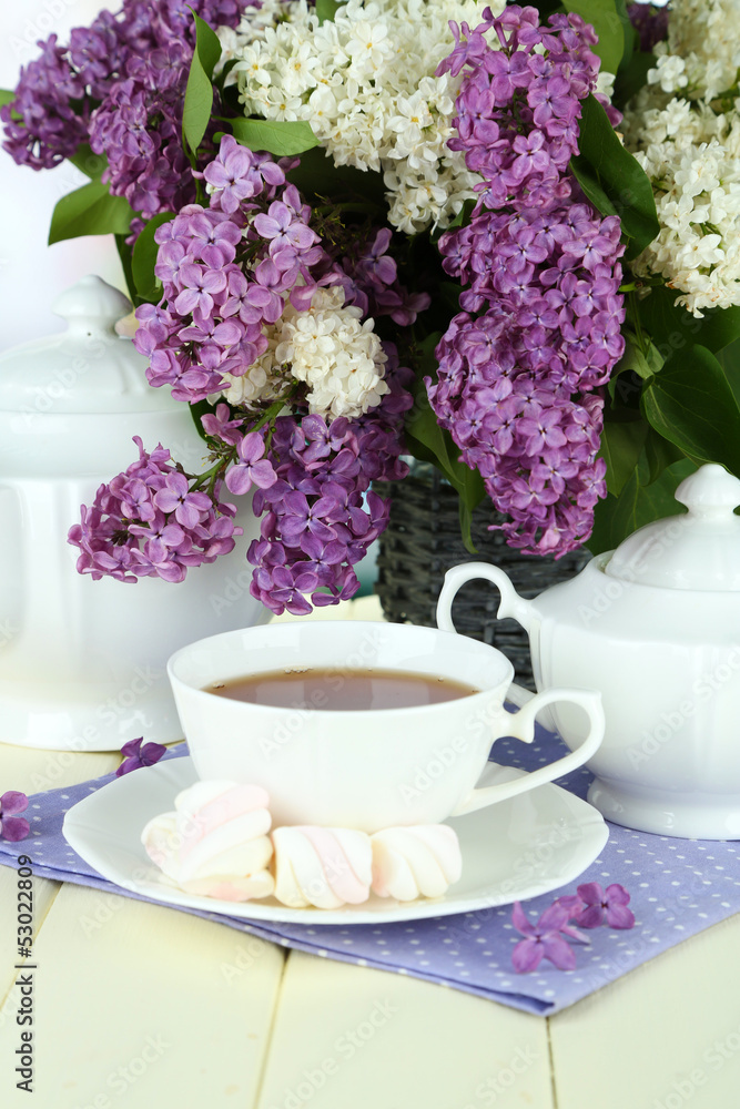 Composition with beautiful lilac flowers, tea service Composition with beautiful lilac flowers, tea service