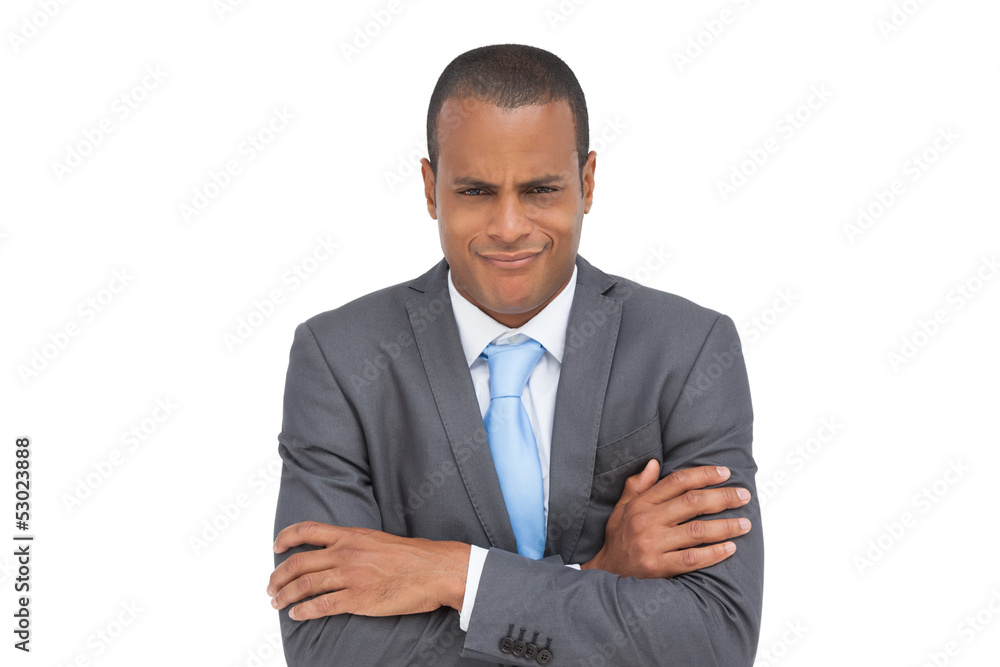 Doubtful businessman with arms crossed Doubtful businessman with arms crossed