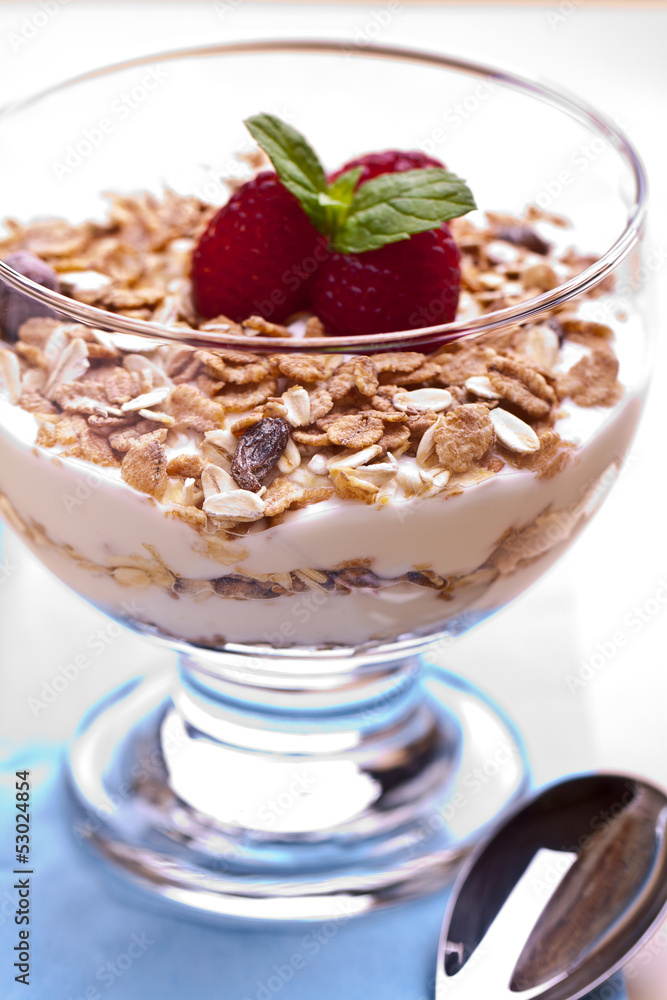 yogurt with muesli and raspberries in small glass yogurt with muesli and raspberries in small glass