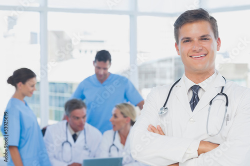 Young doctor with arms folded