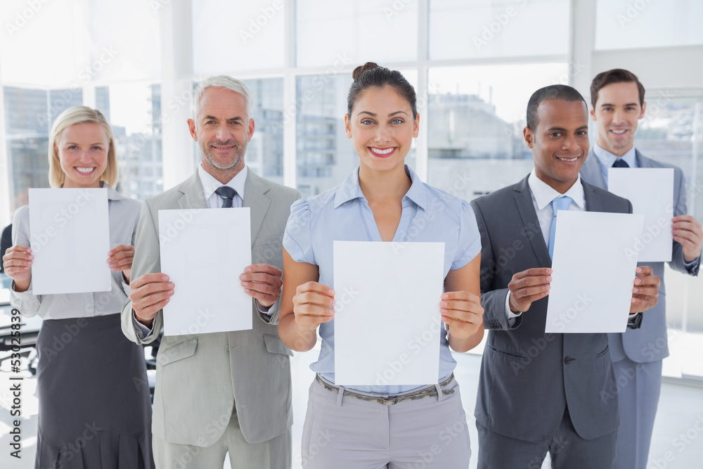 Business team showing blank pages Business team showing blank pages