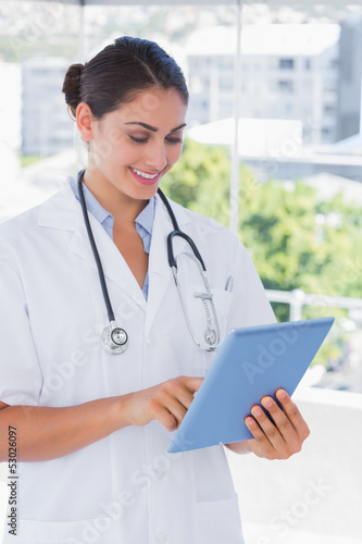 Pretty young doctor using tablet pc
