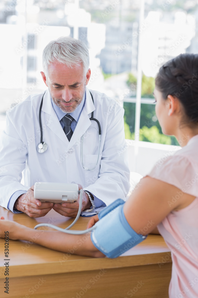 Fototapeta premium Doctor measuring the heartbeat of a patient