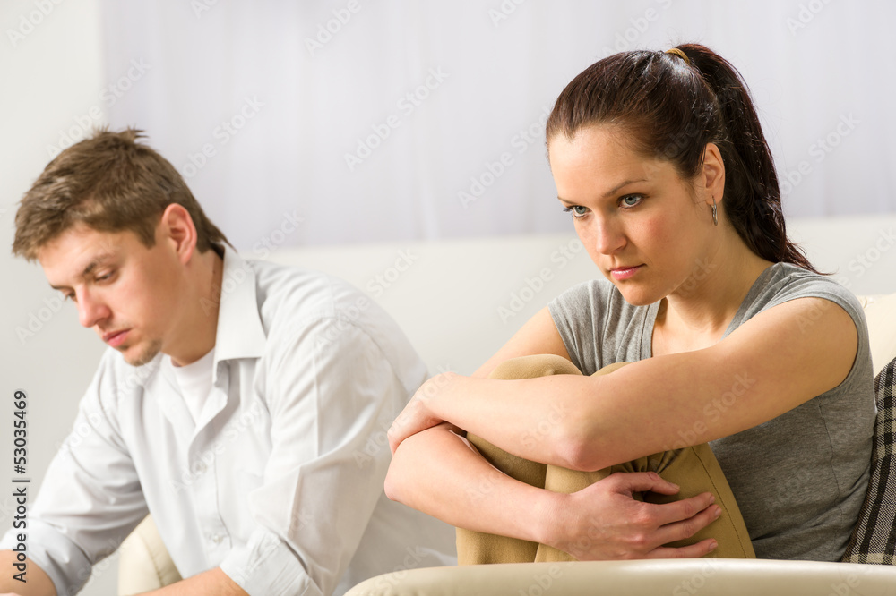 Unhappy couple sitting silently after argument Unhappy couple sitting silently after argument