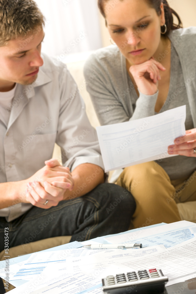 Troubled couple calculating finances Troubled couple calculating finances