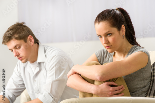 Unhappy couple sitting silently after argument