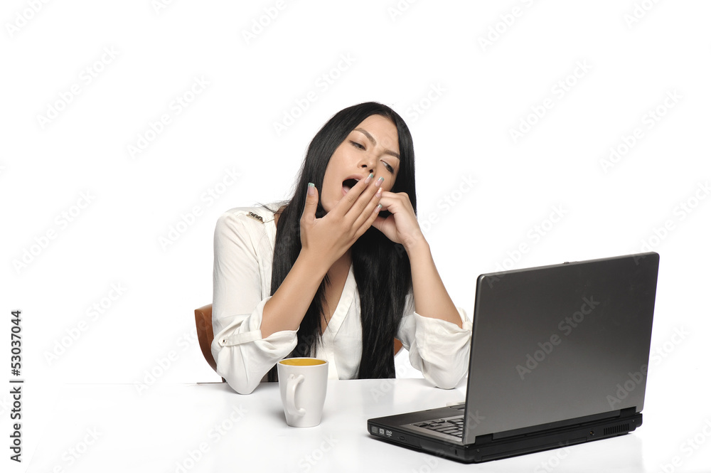 Bored business woman working on laptop Bored business woman working on laptop