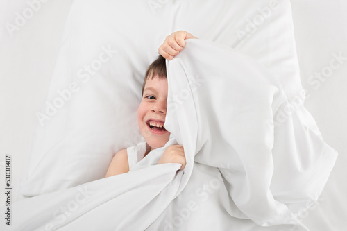 cheerful boy in bed photo