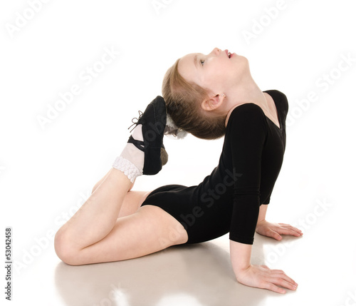 Gymnast cute little girl doing exercises isolated