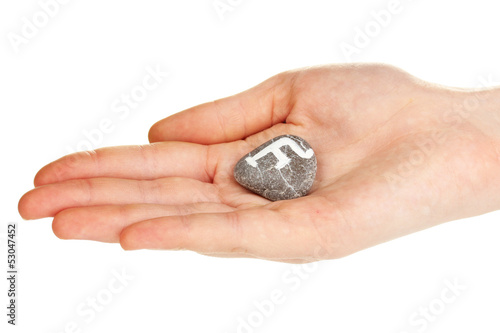 Fortune telling with symbols on stone in hand isolated on