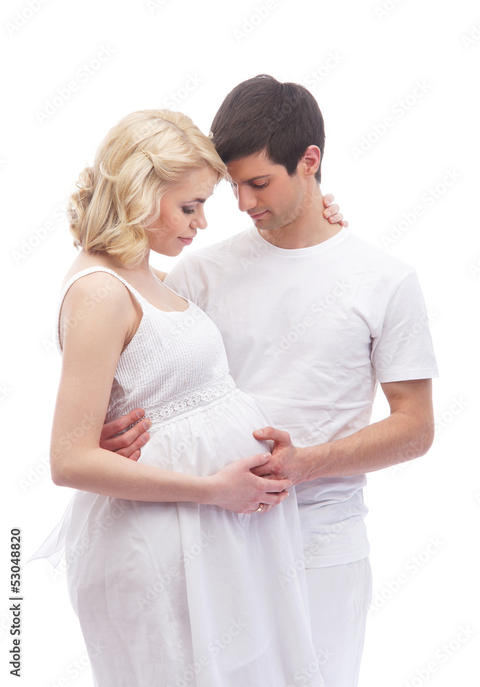 A young and attractive couple: pregnant mother and happy father A young and attractive couple: pregnant mother and happy father