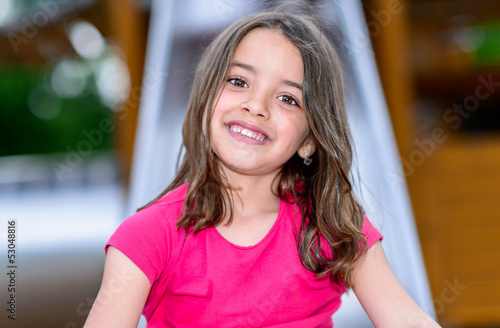 Happy cute little girl in playground