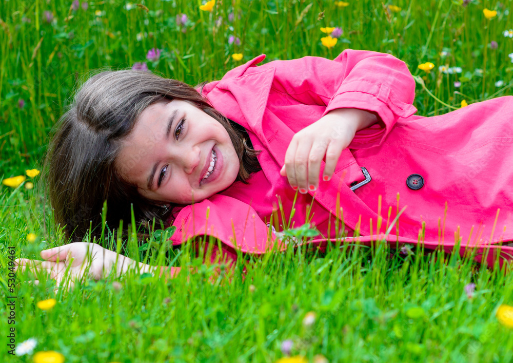 happy cute child lying in a grass of a flower garden happy cute child lying in a grass of a flower garden