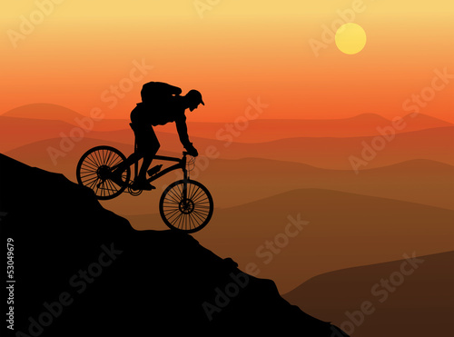 Silhouette of a cyclist with sunset background