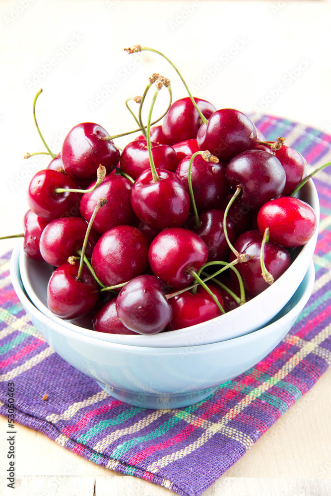 Fresh red summer cherries in bowl on the table Fresh red summer cherries in bowl on the table