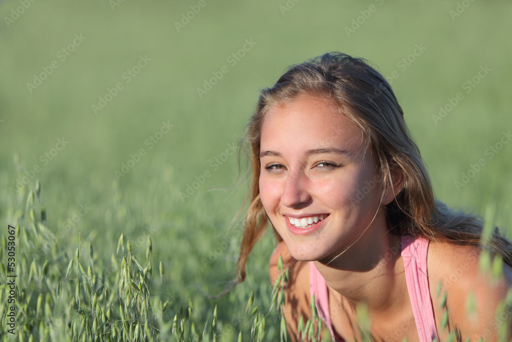 Portrait of a beautiful teenager girl smiling in a oat meadow Portrait of a beautiful teenager girl smiling in a oat meadow
