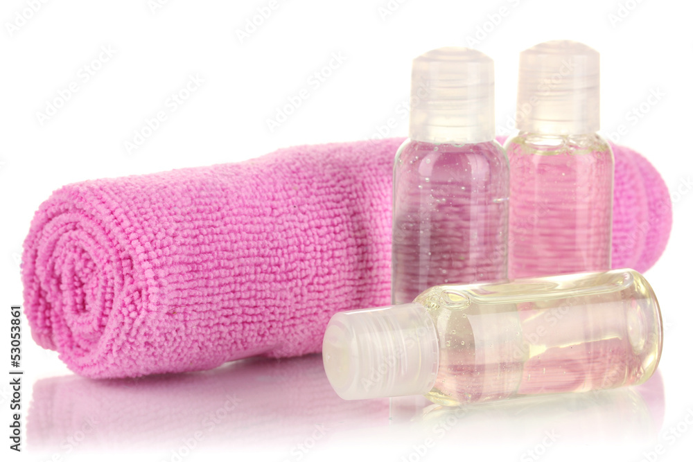 Hotel cosmetic bottles with towel isolated on white Hotel cosmetic bottles with towel isolated on white